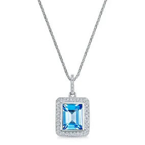 18ct White Gold Emerald Cut Blue Topaz Pendant With Pave Diamond Surround